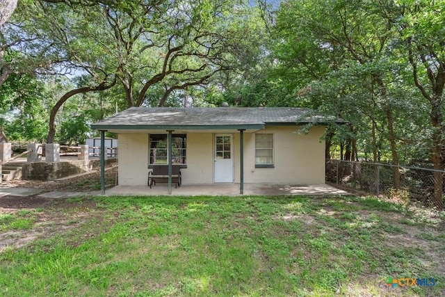 13242 Estate Trl, Belton, TX 76513 - back of house featuring concrete block siding, a patio area, and a shingled roof