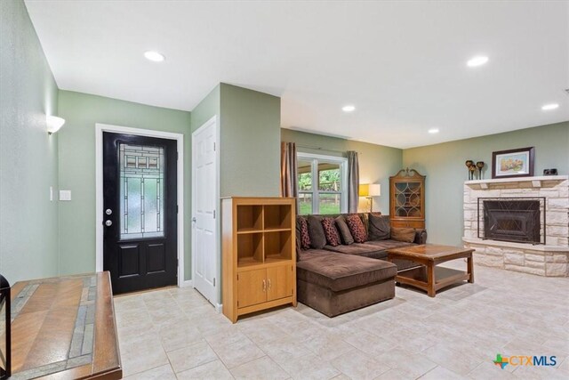 13242 Estate Trl, Belton, TX 76513 - living room with recessed lighting, a stone fireplace, and light tile patterned floors