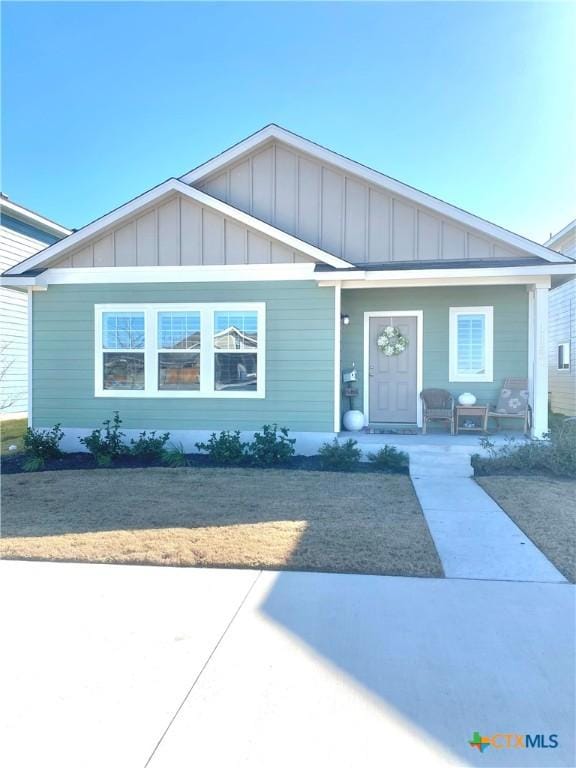 1157 Esplanade Pkwy, San Marcos, TX 78666 - view of front of home with board and batten siding and a porch