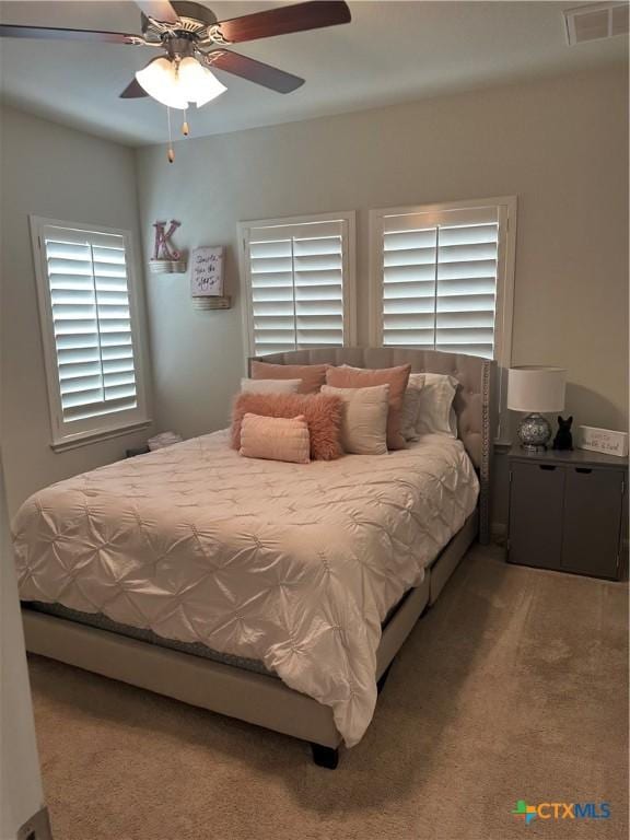 1157 Esplanade Pkwy, San Marcos, TX 78666 - bedroom featuring light colored carpet and a ceiling fan