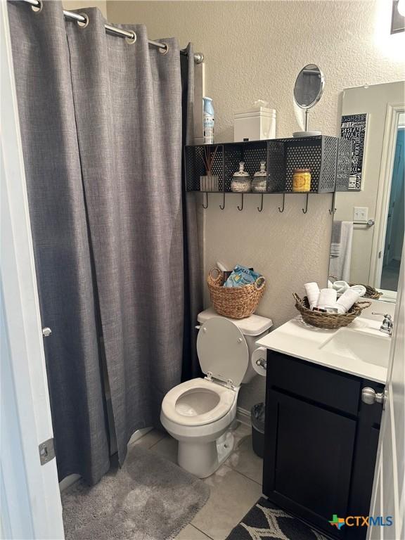 1157 Esplanade Pkwy, San Marcos, TX 78666 - full bath with vanity, tile patterned flooring, and a shower with curtain