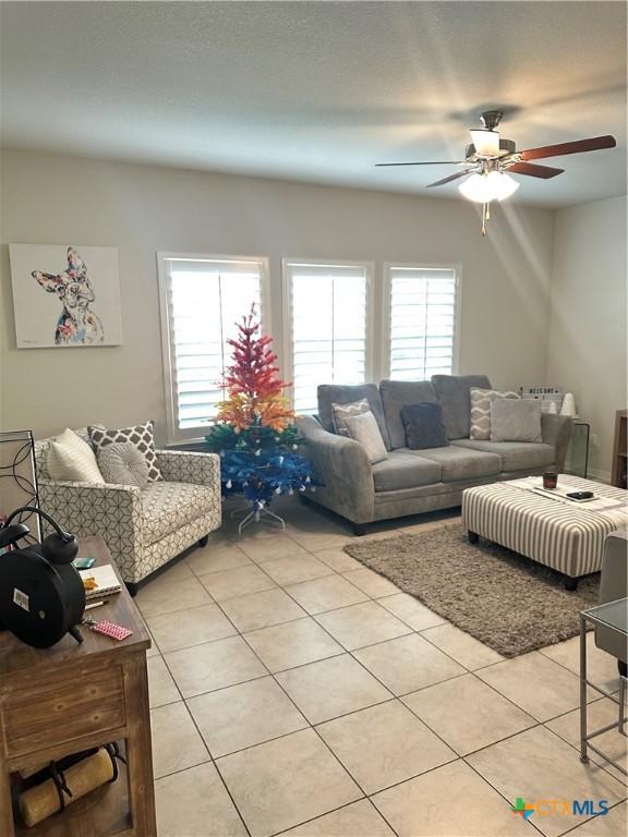1157 Esplanade Pkwy, San Marcos, TX 78666 - living room with light tile patterned floors, ceiling fan, and healthy amount of natural light