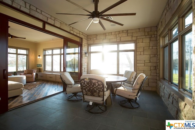 sunroom with plenty of natural light and ceiling fan