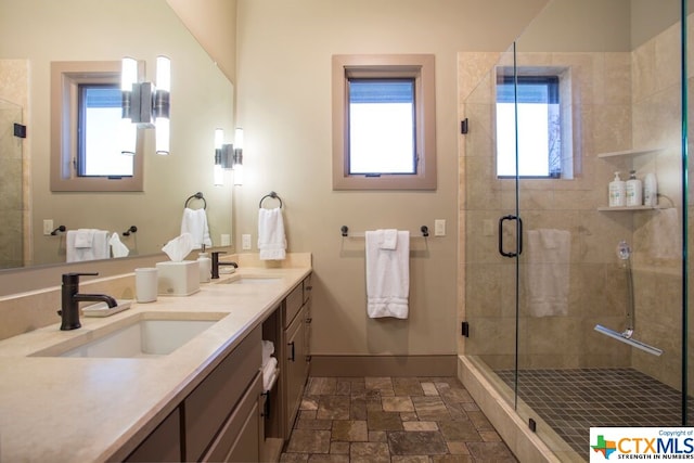 bathroom featuring vanity, an enclosed shower, and a healthy amount of sunlight