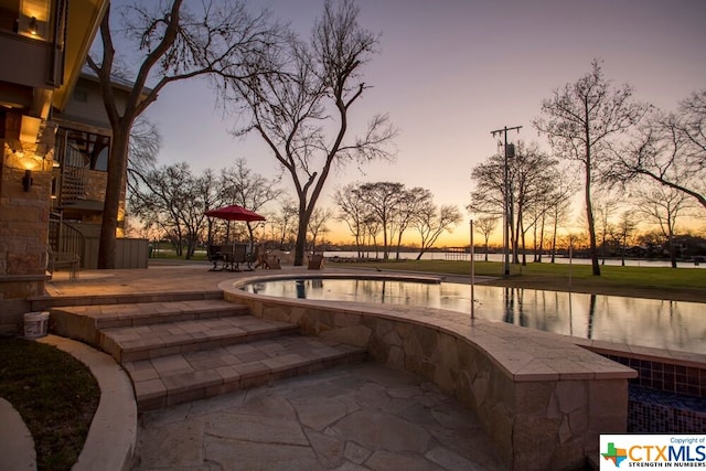 164 Cypress Way, Mcqueeney, TX 78123 - pool at dusk featuring a patio