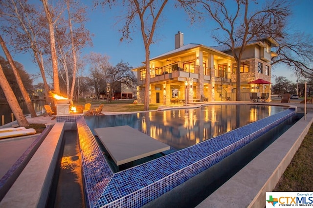 164 Cypress Way, Mcqueeney, TX 78123 - view of pool with an outdoor fire pit, an infinity pool, a patio area, and stairs