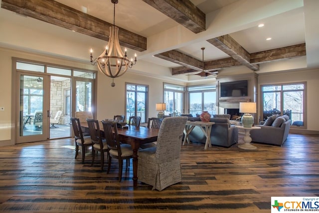 dining space with dark hardwood / wood-style floors, beam ceiling, an inviting chandelier, and coffered ceiling