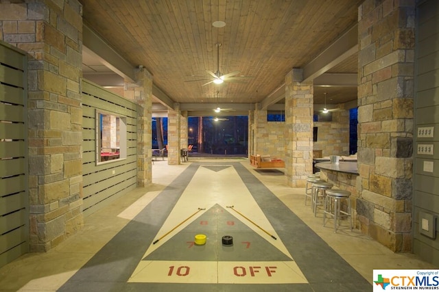 rec room with ornate columns, ceiling fan, and wood ceiling