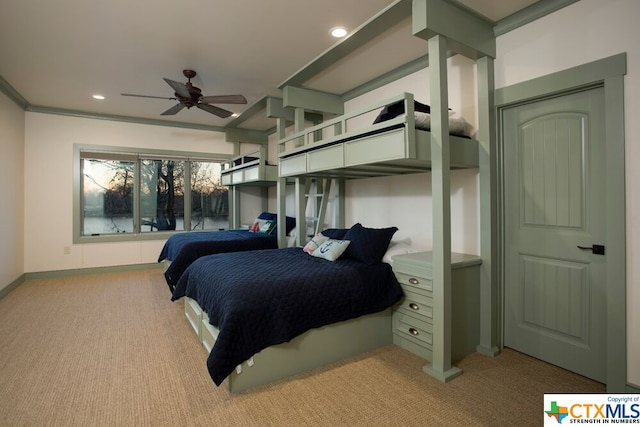 carpeted bedroom featuring ornamental molding and ceiling fan