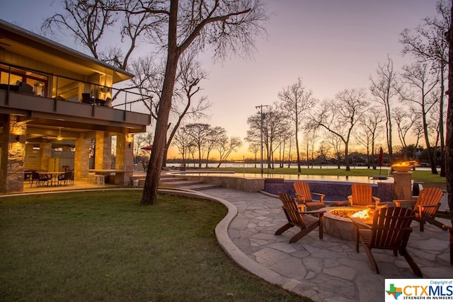 exterior space with a fire pit, a balcony, and a patio area