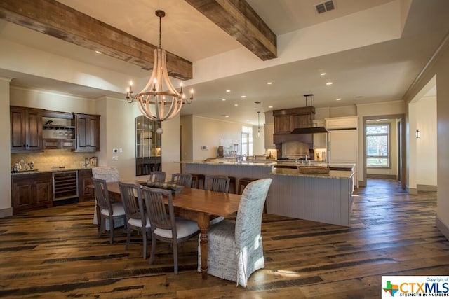 dining room with an inviting chandelier, beamed ceiling, dark hardwood / wood-style floors, crown molding, and wine cooler