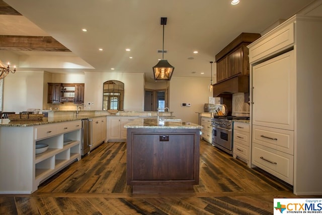 kitchen featuring stainless steel appliances, white cabinetry, light stone countertops, decorative light fixtures, and dark wood-type flooring