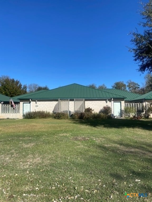 view of side of property with a yard