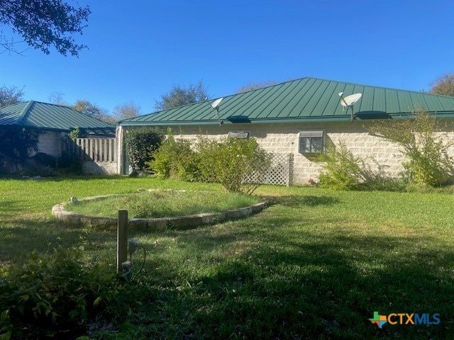 view of home's exterior with a lawn