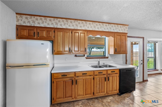 kitchen featuring dishwasher, a textured ceiling, sink, and white refrigerator