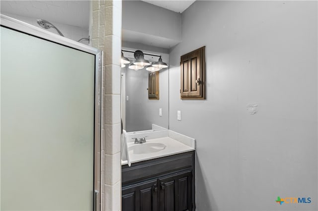 bathroom with walk in shower and vanity