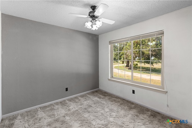 carpeted empty room with a textured ceiling and ceiling fan