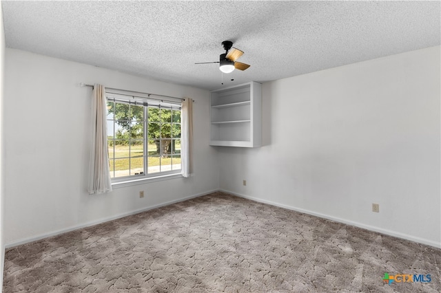 unfurnished room featuring a textured ceiling, light carpet, and ceiling fan