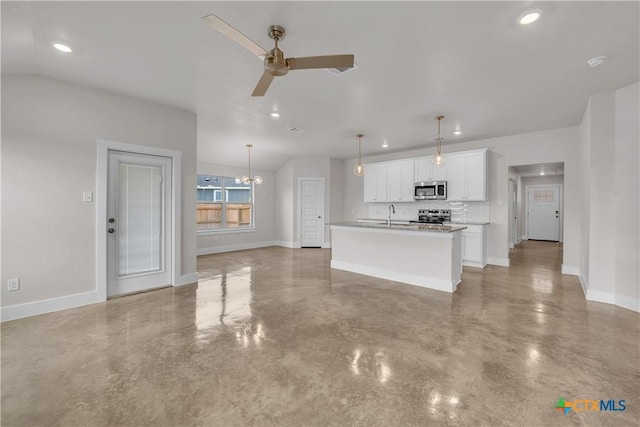 interior space featuring stainless steel appliances, concrete flooring, baseboards, and a ceiling fan