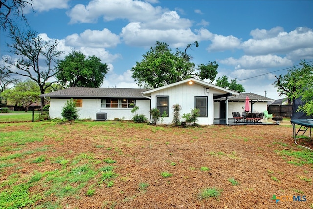 2005 Park Ln, Georgetown, TX 78628 - view of front of property with a trampoline, a patio area, central AC unit, and board and batten siding