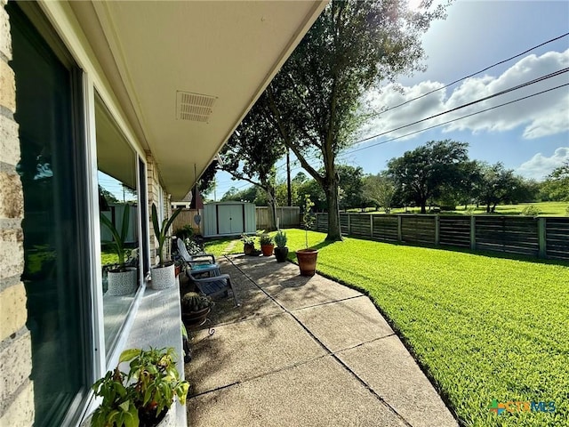 107 Savannah Dr, Victoria, TX 77904 - fenced backyard with a storage shed and a patio