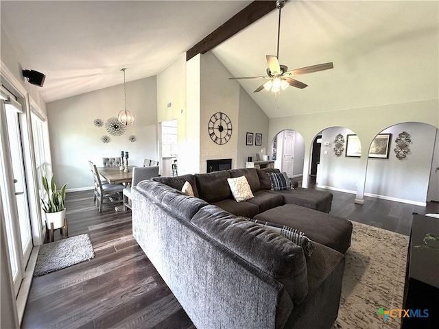 107 Savannah Dr, Victoria, TX 77904 - living area featuring arched walkways, a ceiling fan, dark wood-style flooring, beam ceiling, and high vaulted ceiling