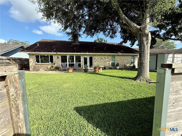 107 Savannah Dr, Victoria, TX 77904 - rear view of house featuring a storage shed and brick siding
