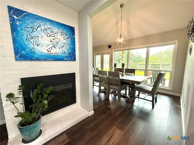107 Savannah Dr, Victoria, TX 77904 - dining space featuring dark wood-style flooring, lofted ceiling, a fireplace, and french doors