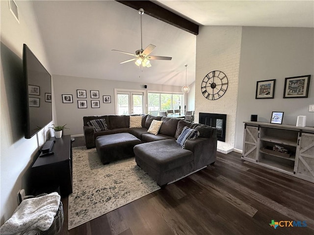107 Savannah Dr, Victoria, TX 77904 - living room featuring a ceiling fan, dark wood finished floors, beamed ceiling, a brick fireplace, and high vaulted ceiling
