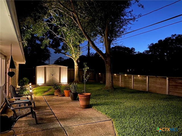 107 Savannah Dr, Victoria, TX 77904 - fenced backyard with a storage unit and a patio area