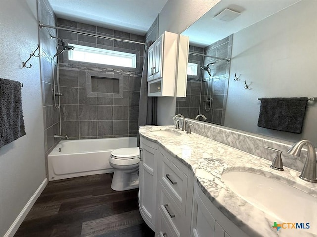 107 Savannah Dr, Victoria, TX 77904 - bathroom featuring  shower combination, double vanity, and wood finished floors