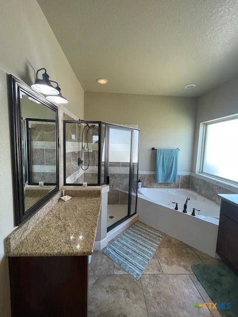5618 County Road 3300, Kempner, TX 76539 - full bathroom featuring vanity, a garden tub, a shower stall, tile patterned flooring, and a textured ceiling