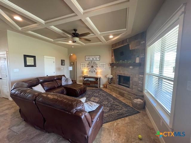 5618 County Road 3300, Kempner, TX 76539 - living room featuring plenty of natural light, coffered ceiling, arched walkways, beamed ceiling, and a large fireplace