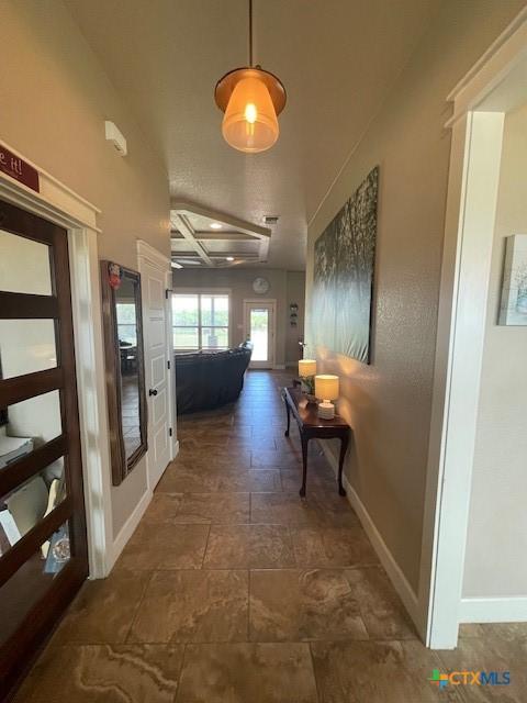 5618 County Road 3300, Kempner, TX 76539 - hall with coffered ceiling, baseboards, stone finish flooring, and beam ceiling