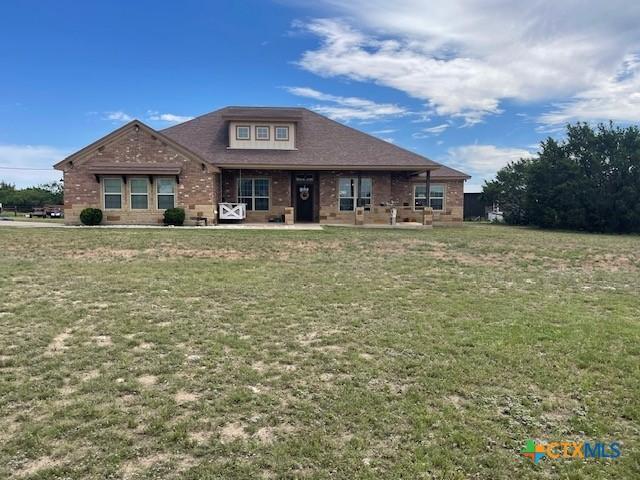 5618 County Road 3300, Kempner, TX 76539 - view of front facade featuring a front yard, brick siding, and a patio