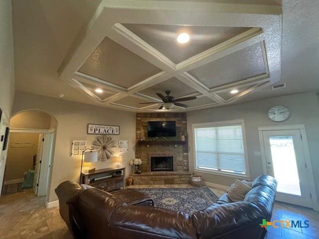 5618 County Road 3300, Kempner, TX 76539 - living room with arched walkways, a fireplace, ceiling fan, baseboards, and coffered ceiling