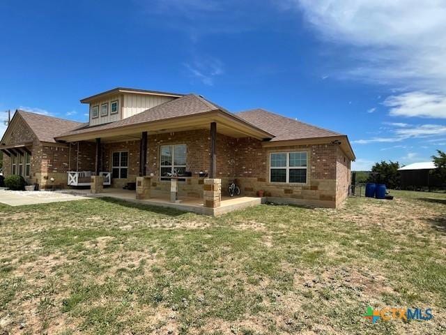 5618 County Road 3300, Kempner, TX 76539 - rear view of house with a patio area, brick siding, a yard, and roof with shingles