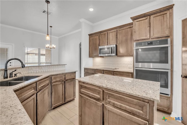 kitchen featuring sink, stainless steel appliances, light tile patterned floors, light stone counters, and a chandelier