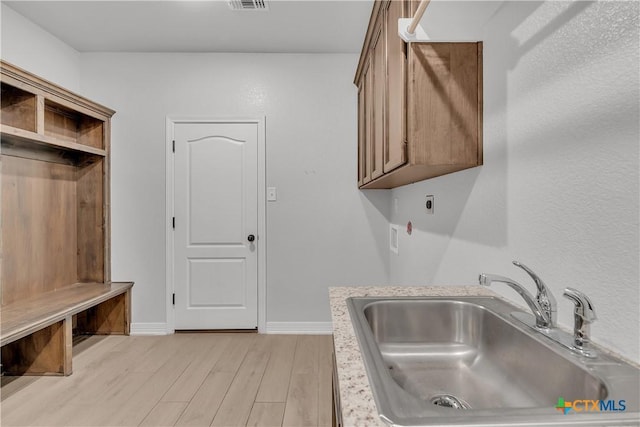 interior space featuring sink and light hardwood / wood-style flooring