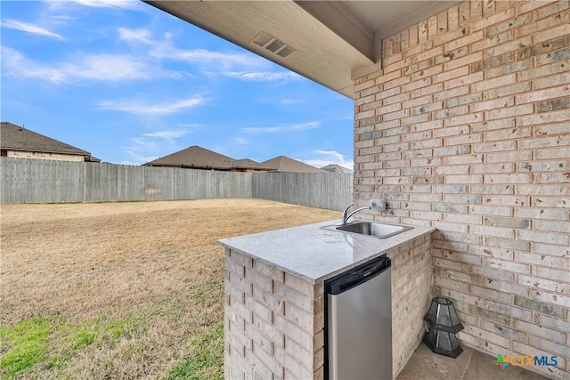 view of patio featuring area for grilling and sink