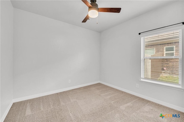 carpeted empty room featuring ceiling fan