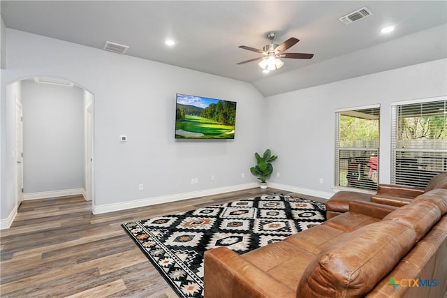 living room with lofted ceiling, wood-type flooring, and ceiling fan