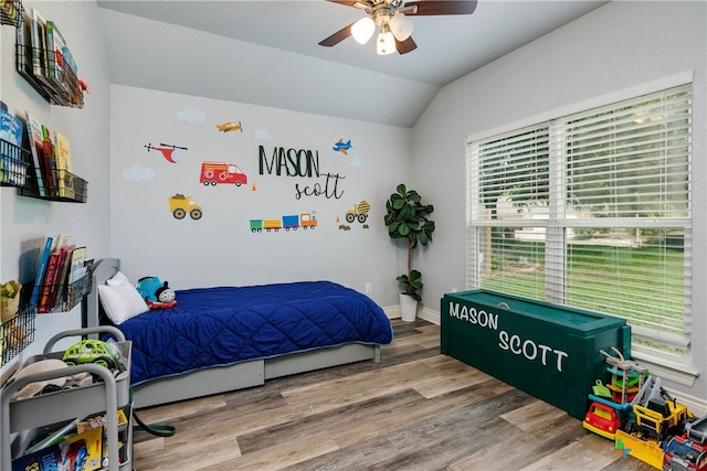 bedroom with hardwood / wood-style flooring, lofted ceiling, and ceiling fan