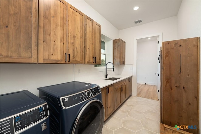 7817 W Fm 487, Florence, TX 76527 - laundry area featuring recessed lighting, washer and dryer, visible vents, a sink, and cabinet space