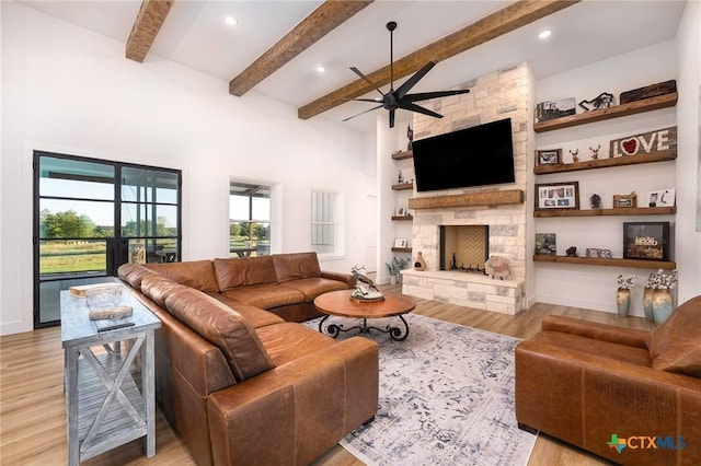 7817 W Fm 487, Florence, TX 76527 - living room featuring wood finished floors, a fireplace, beamed ceiling, ceiling fan, and recessed lighting