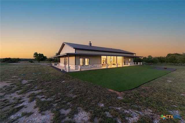 7817 W Fm 487, Florence, TX 76527 - back of house at dusk with a patio and a lawn