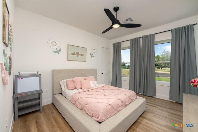 7817 W Fm 487, Florence, TX 76527 - bedroom featuring light wood finished floors, baseboards, ceiling fan, and visible vents