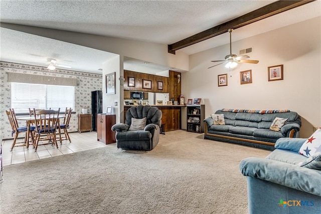 carpeted living room featuring ceiling fan, lofted ceiling with beams, and a textured ceiling