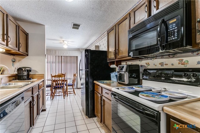 kitchen with sink, a textured ceiling, white dishwasher, range with electric cooktop, and ceiling fan