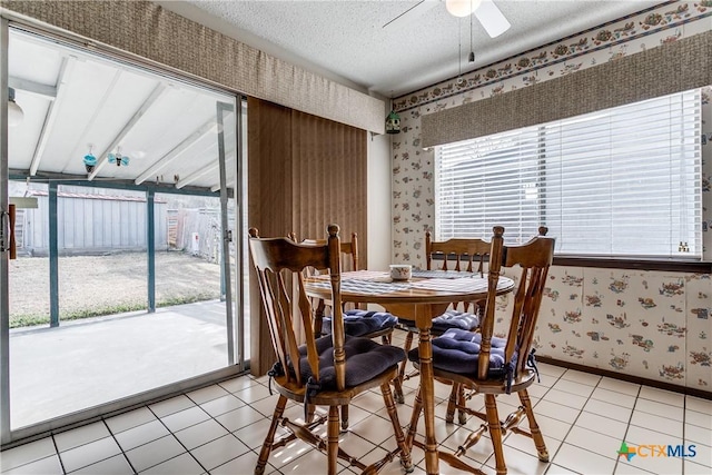 tiled dining area with a healthy amount of sunlight and a textured ceiling